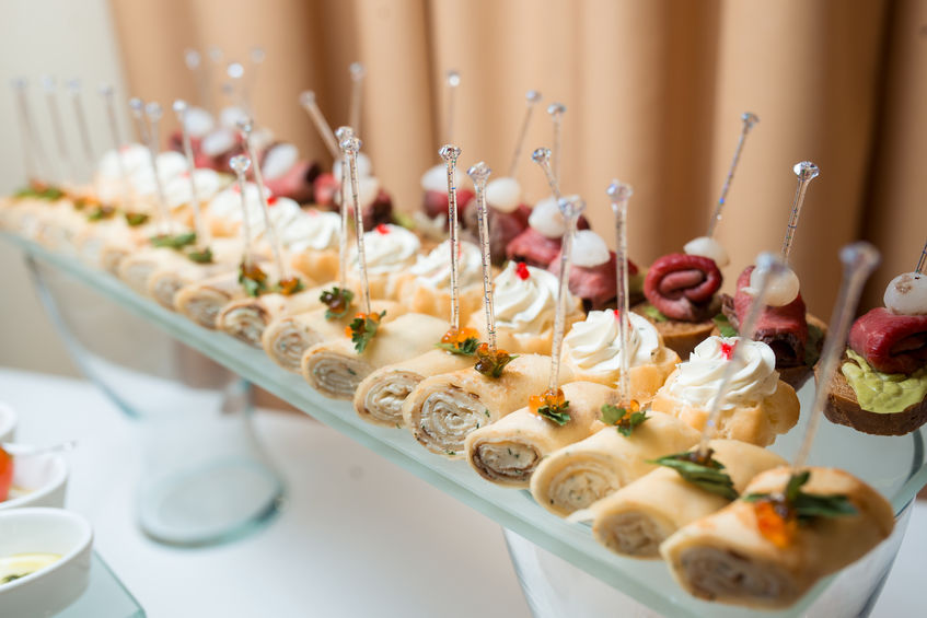 Сatering banquet table with different snacks and desserts