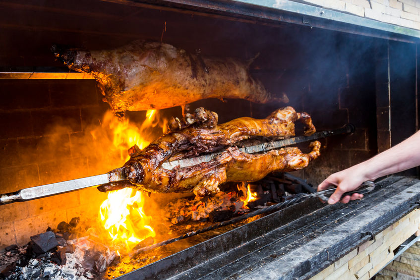 Pig on a grill. traditional coal and fire