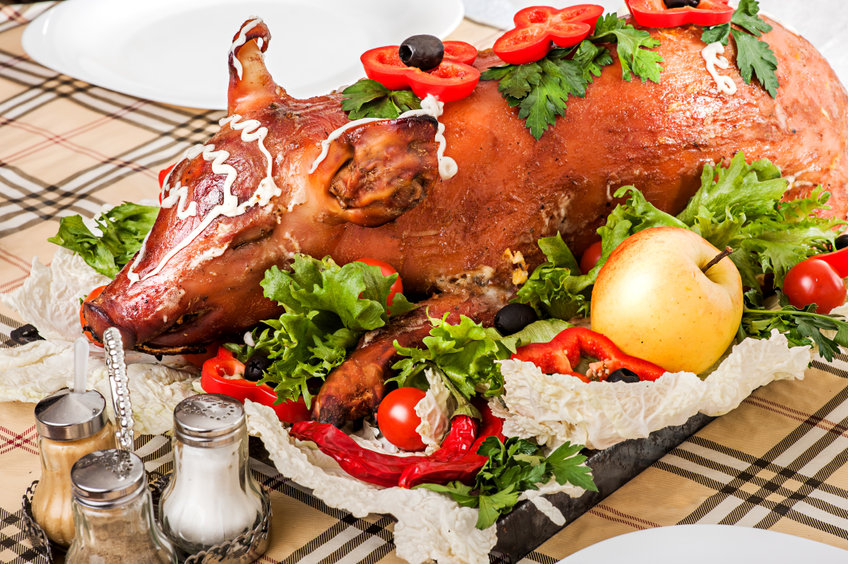 Decorated and roast suckling pig on a table on banquet at restaurant