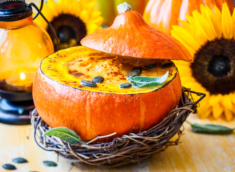 Cream of pumpkin soup with pumpkin seeds and sage  in pumpkin.