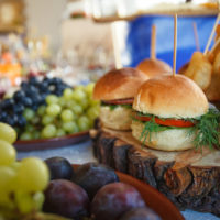 Burgers with vegetables and fruits on the buffet.